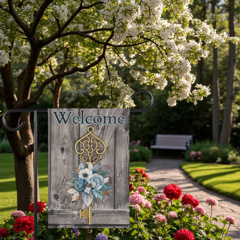 Welcome Garden Flag, Vintage Cottage Outdoor Decor displayed on a garden flagpole next to blooming flowers, emphasizing its placement versatility